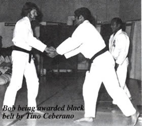Bob Jones receiving his Black Belt from Tino Ceberano